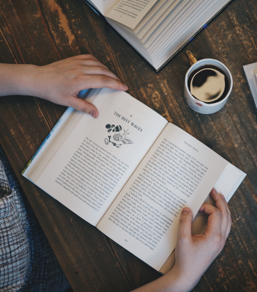 A reader opens one of Unbound's published books